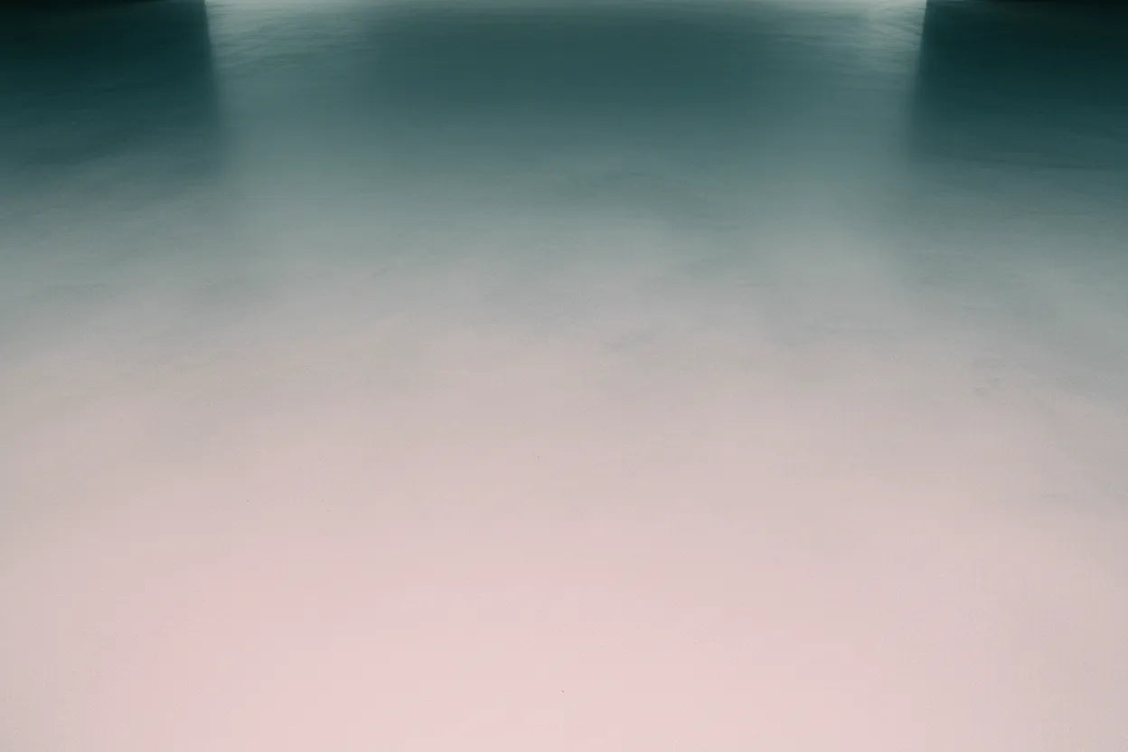 Gradient concrete background transitioning from dark blue to light pink