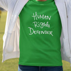 Irish Green Human Rights Defender long sleeve tee styled with white jacket, white graphic, outdoor lifestyle front view.