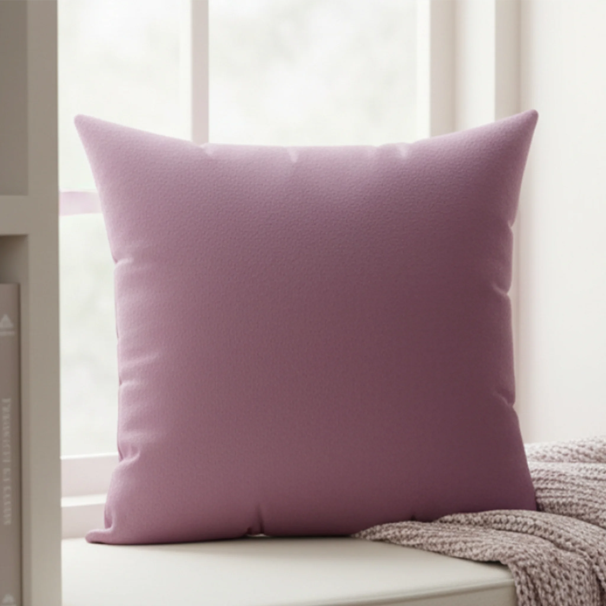 Lavender red faux suede pillow styled on sofa, rich reddish purple home decor.