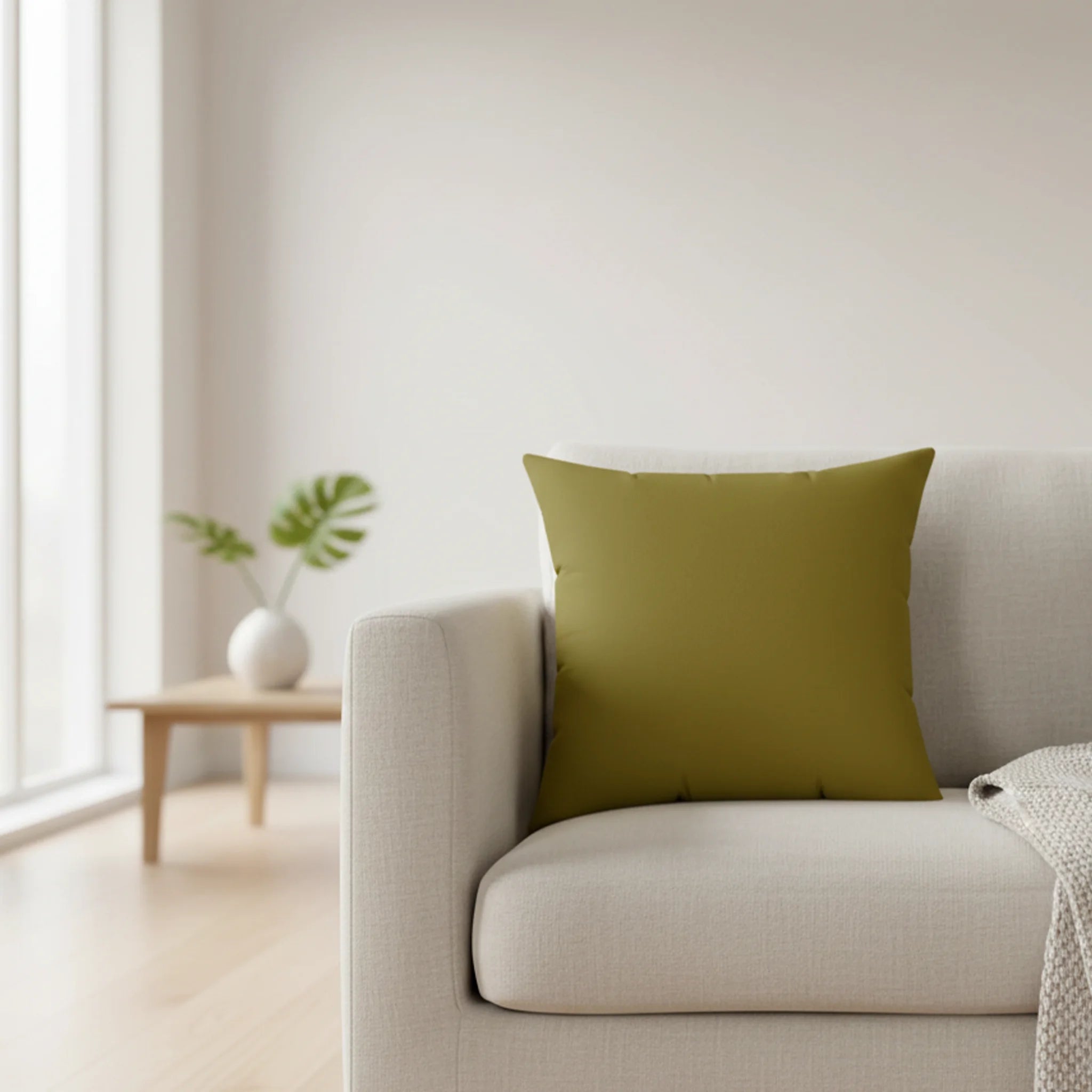 Lemon olive faux suede throw pillow styled on a couch in a soft Nordic soft brutalist studio.