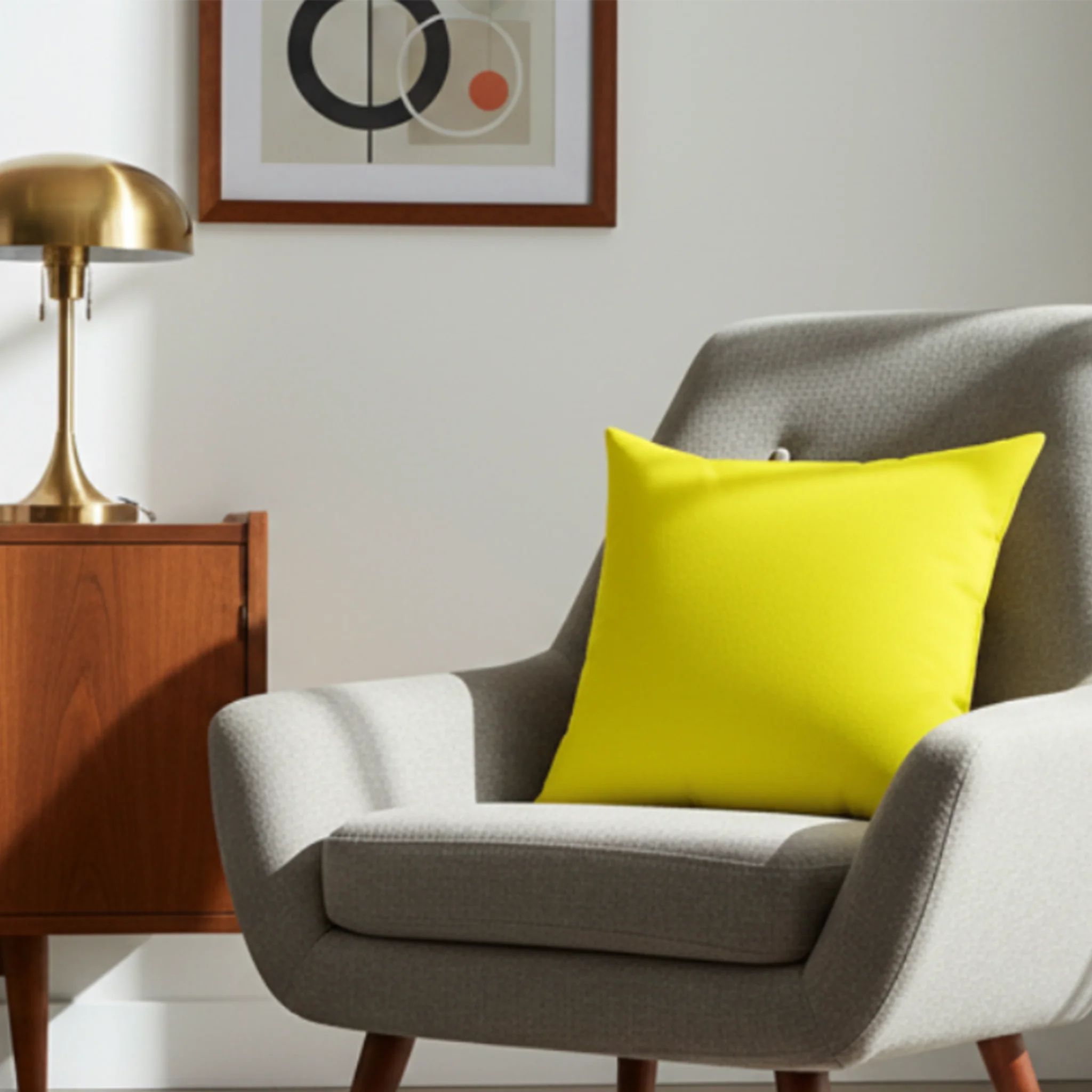 Lemon yellow faux suede throw pillow styled in a modern sofa chair in a bright airy living room.