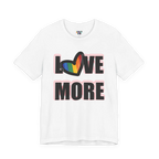 Love More Rainbow Heart Pride Tee, white, bold LOVE MORE graphic with rainbow heart, front view.