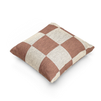 A side view of the Mimosa Pink Woven Checker Pillow, showing a mimosa pink checker pattern on an oatmeal cream colored background. 
