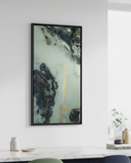 The ‘Tu Gough’ 30x60, black framed canvas abstract home decor wall art on a white wall above a kitchen counter with decor items.