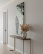 Modern interior with a console table, vase with dried plants, and the ’Tu Gough' abstract wall art.