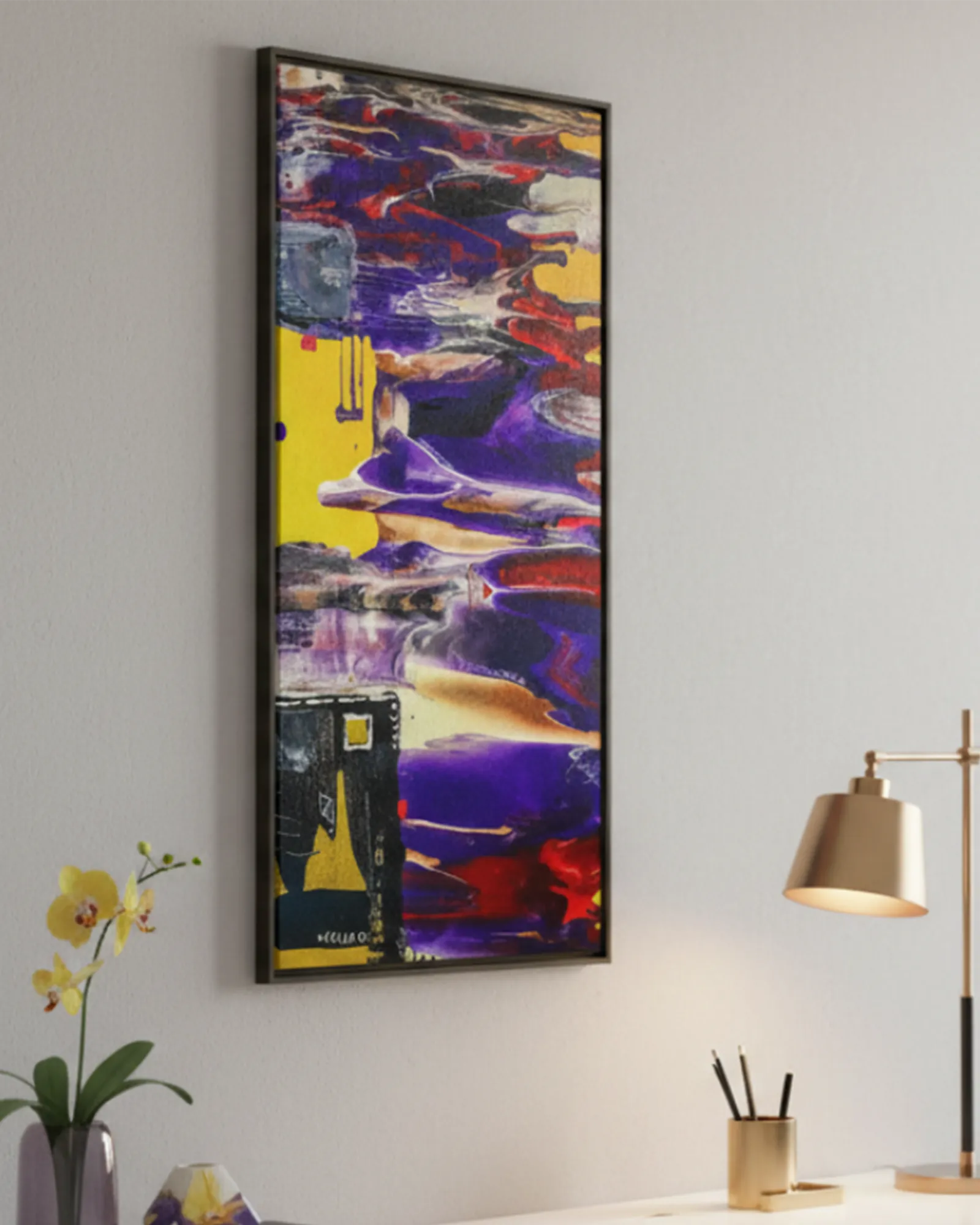 Colorful abstract ‘Tribal Wave’ espresso framed canvas painting on a wall with a desk that has a rose gold lamp and yellow plant in the foreground.