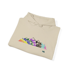 Folded sand-colored pullover hoodie showing a multicolored Pride mountain and evergreen tree graphic, with the hood and drawstrings visible.