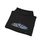 Folded black pullover hoodie showing a purple, turquoise and gray mountain and evergreen tree graphic, with the hood and drawstrings visible.
