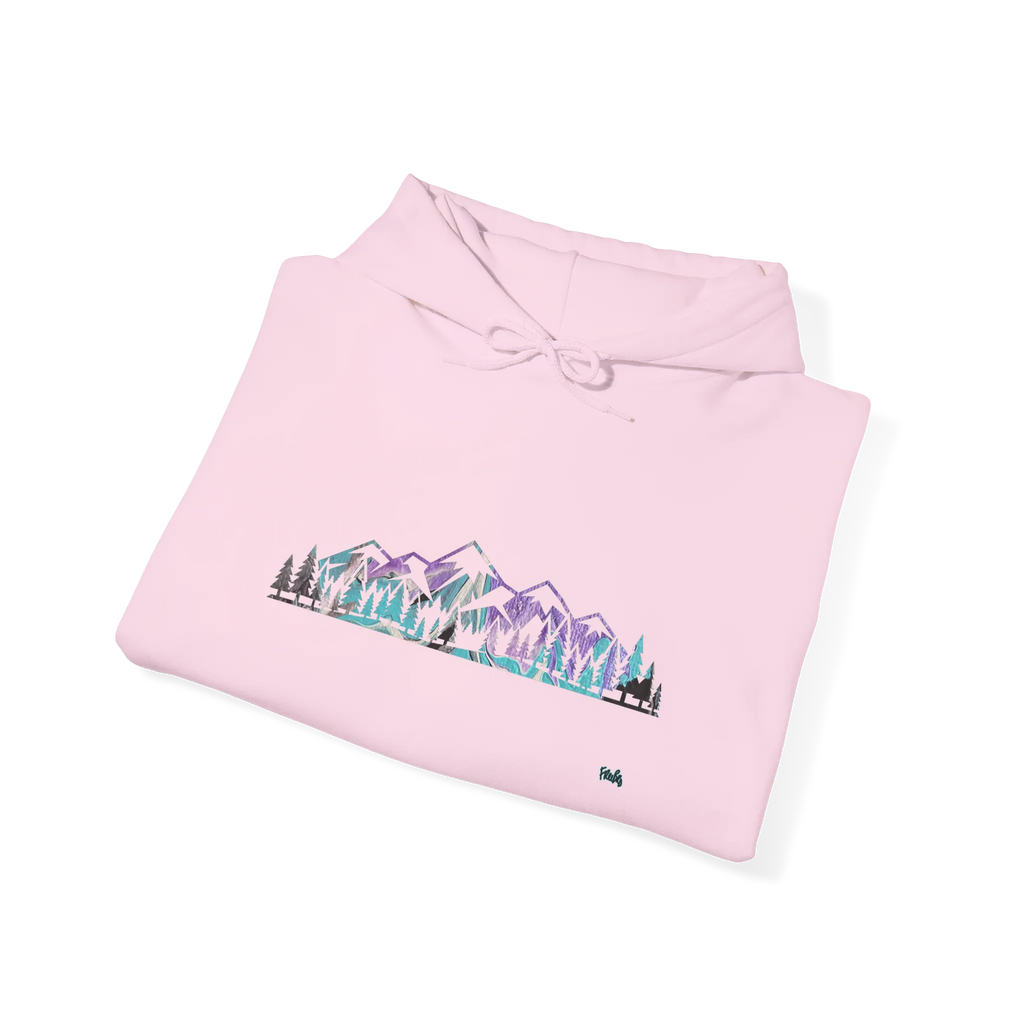 Folded light pink pullover hoodie showing a purple, turquoise and gray mountain and evergreen tree graphic, with the hood and drawstrings visible.