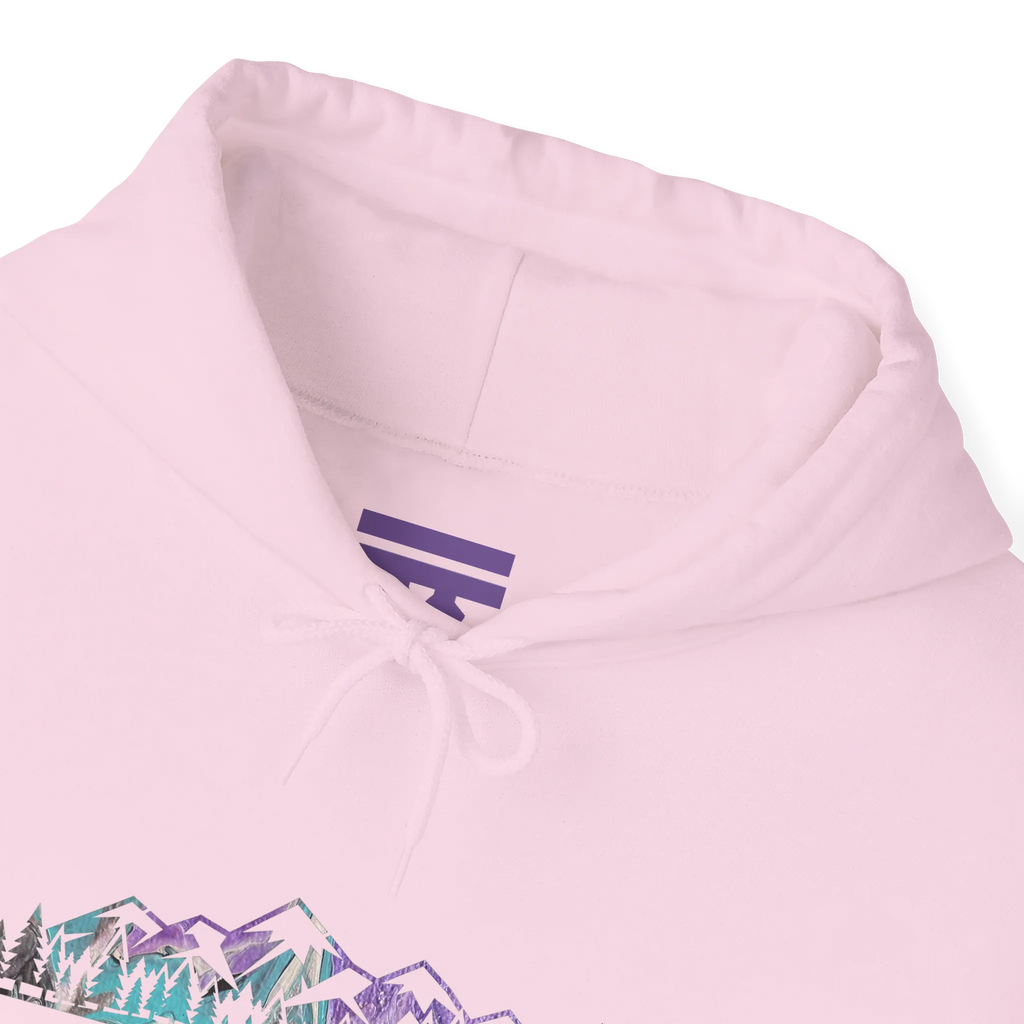 Close-up of a light pink hoodie neckline showing a purple inner-neck logo, pink drawstrings and part of the mountain graphic.