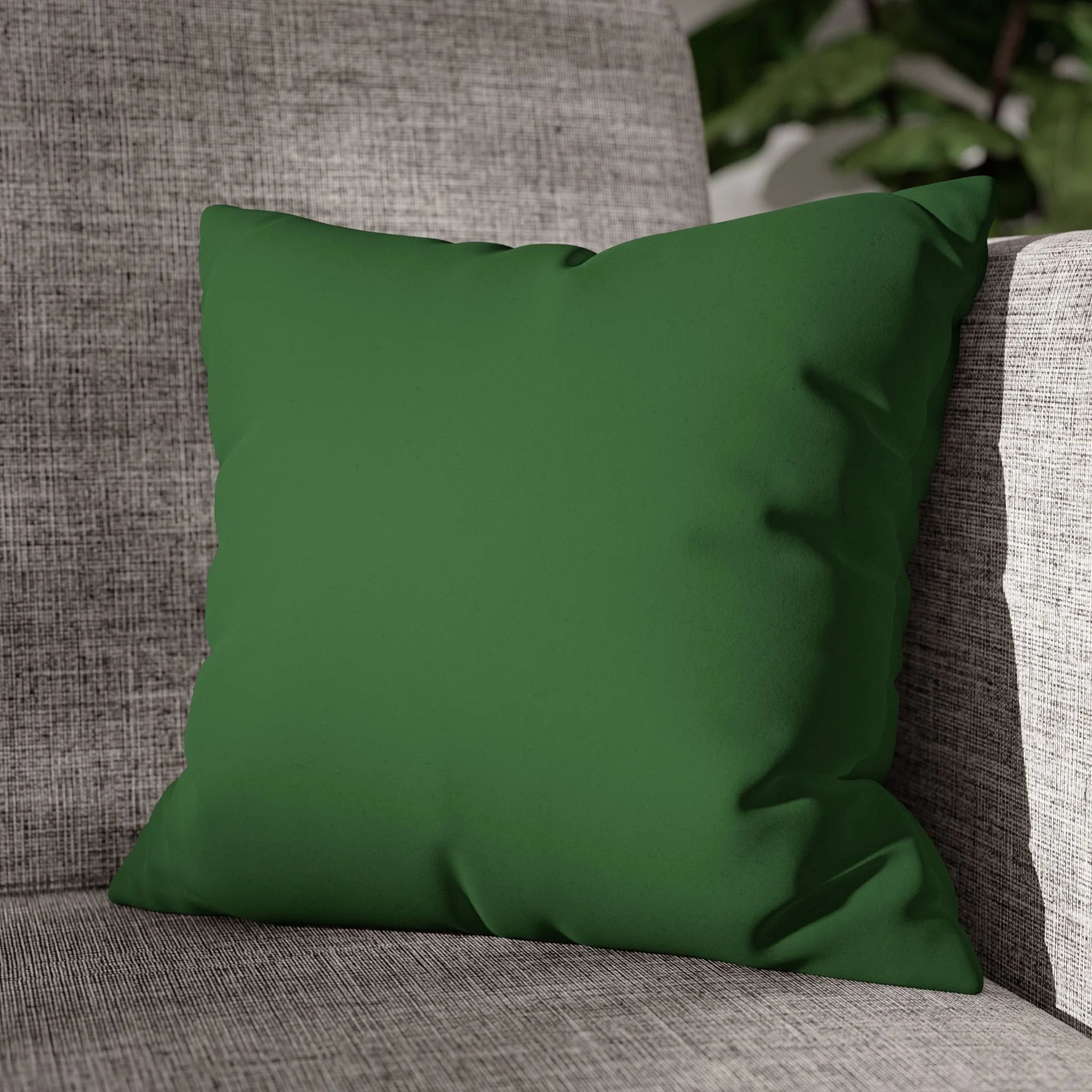 Mughal Green faux suede pillow case styled on a couch in a modern living room.