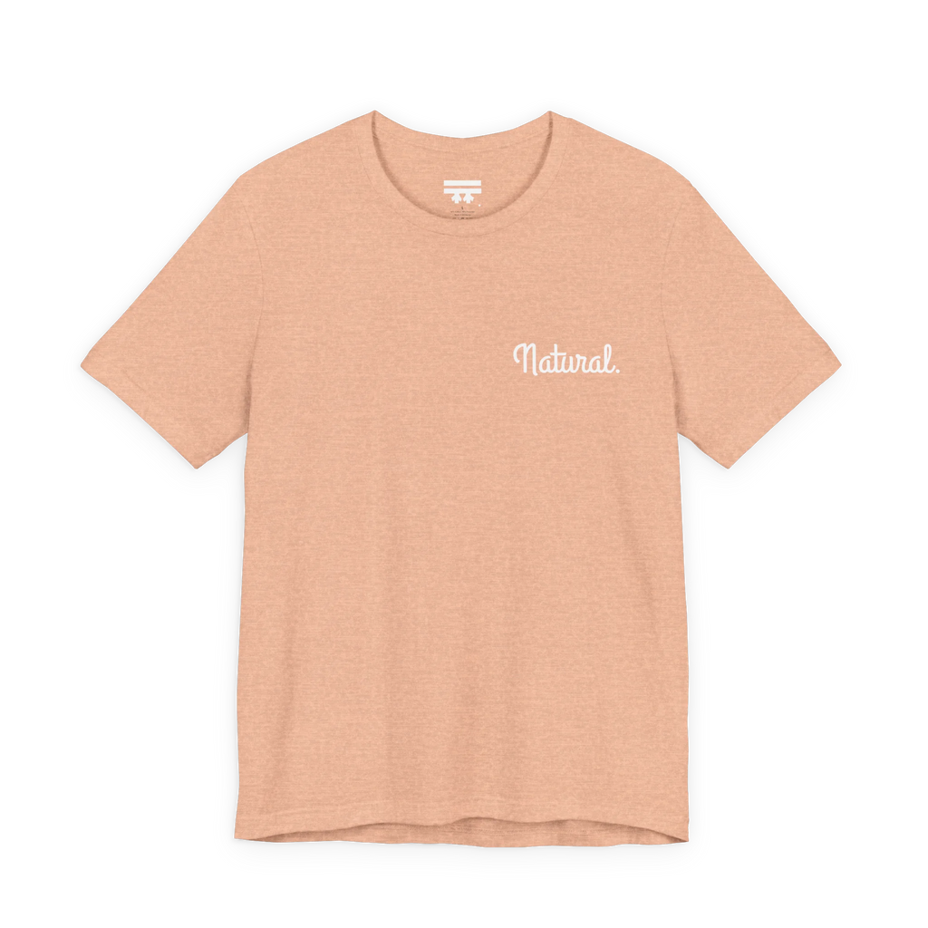 Natural script tee, heather peach, front chest bold white text that says “Natural."
