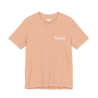 Natural script tee, heather peach, front chest bold white text that says “Natural."