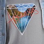 A sport grey FREEBRD Natural State of Mind tee worn under an open denim jacket, featuring the Arkansas river diamond graphic and red 'Arkansas’ script.