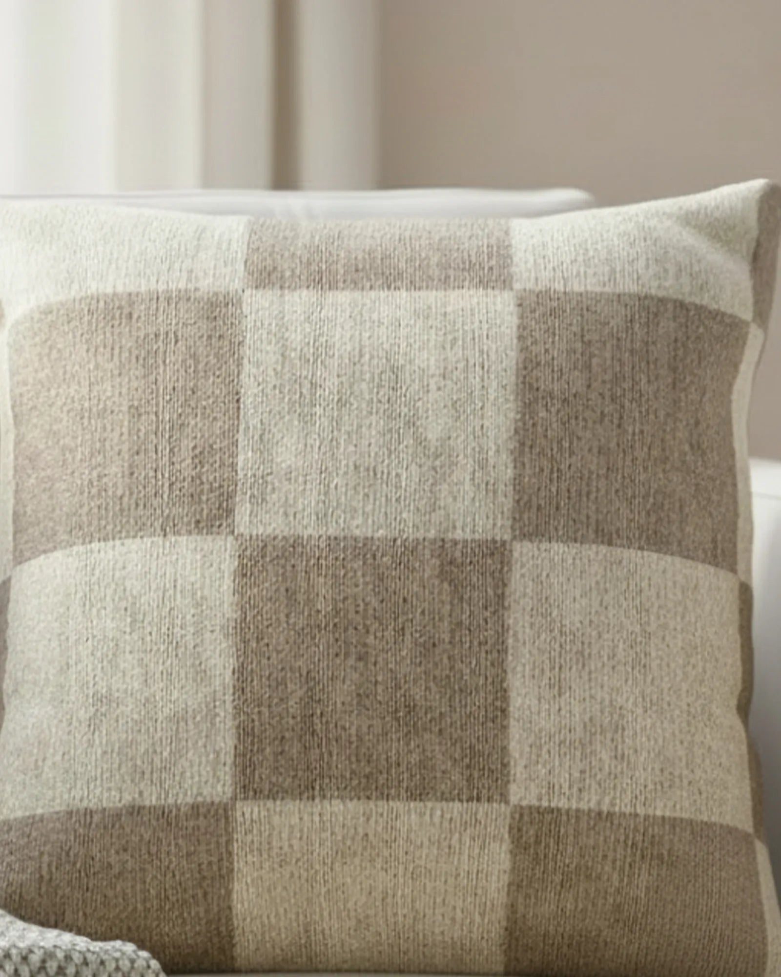 White linen armchair in a soft minimalist living room with sheer curtains and natural window light styled with the Neutral Beige Checkered Woven Pillow.