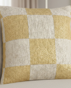 Close-up texture detail of the Neutral Yellow Checkered Woven Pillow showing golden yellow and ivory woven checker squares on a cream fabric armchair.