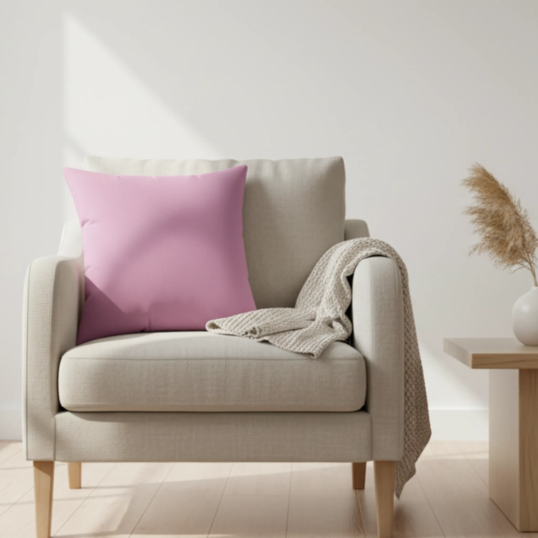 Pastel violet faux suede throw pillow on cream armchair with knit blanket, Nordic living room lifestyle view.