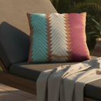 Boho chevron outdoor pillow on teak sofa, golden hour lifestyle, teal cream magenta terracotta.