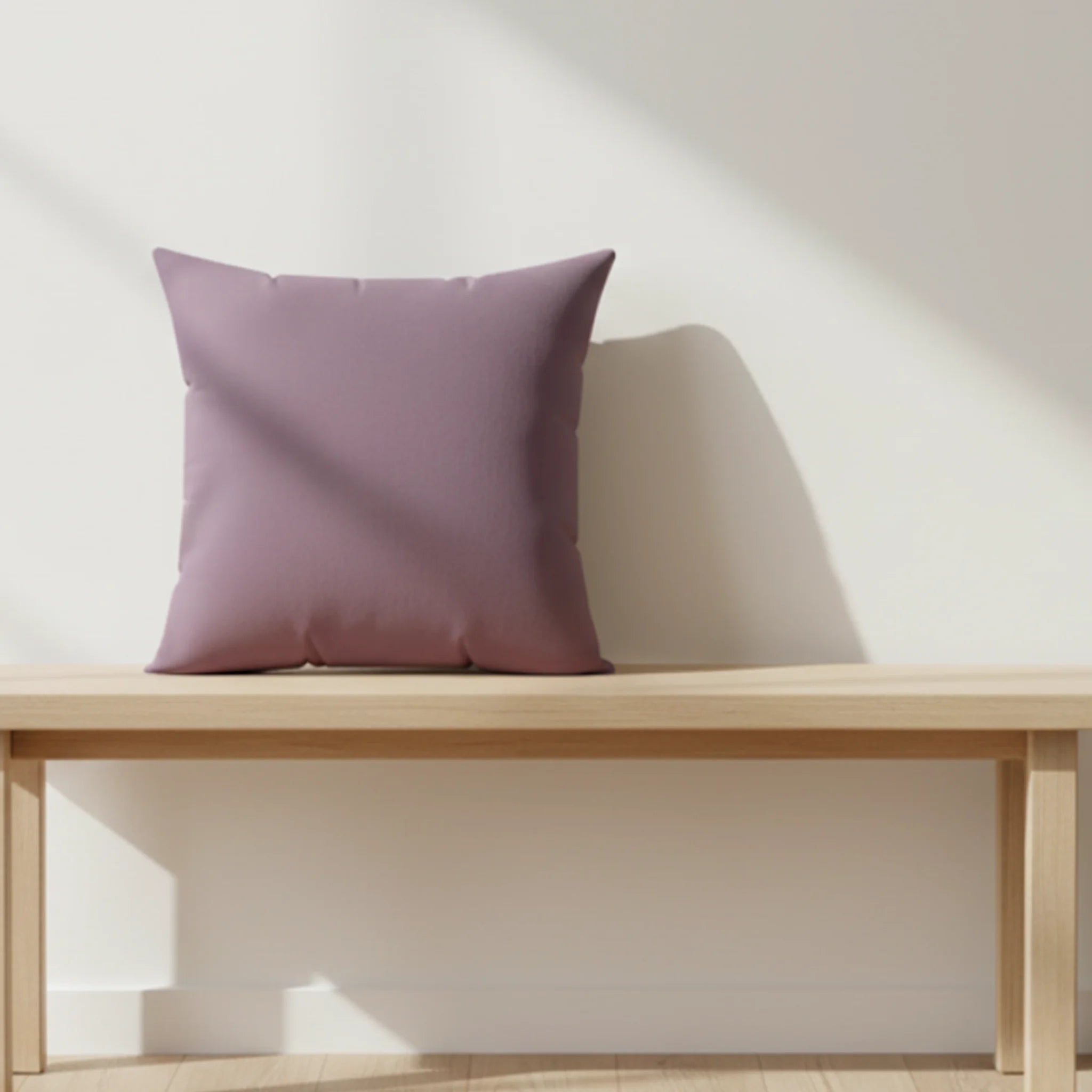 Old lavender faux suede throw pillow styled on a wooden bench in a soft nordic living room.