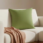 Olive green faux suede throw pillow styled on a on couch in living room, lifestyle view.