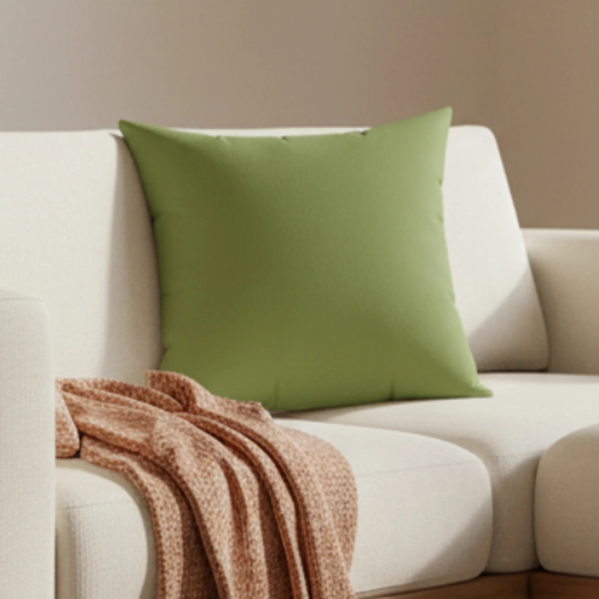 Olive green faux suede throw pillow styled on a on couch in living room, lifestyle view.