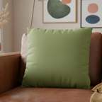Olive Green faux suede pillowcase styled on a sofa chair in a modern living room. 