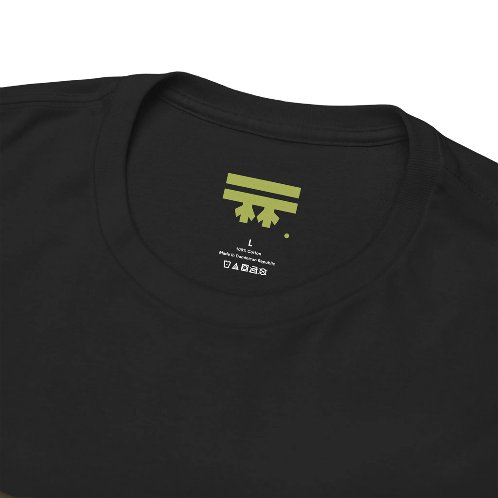 Black graphic tee collar detail showing FREEBRD branded inner label, size and care info visible.