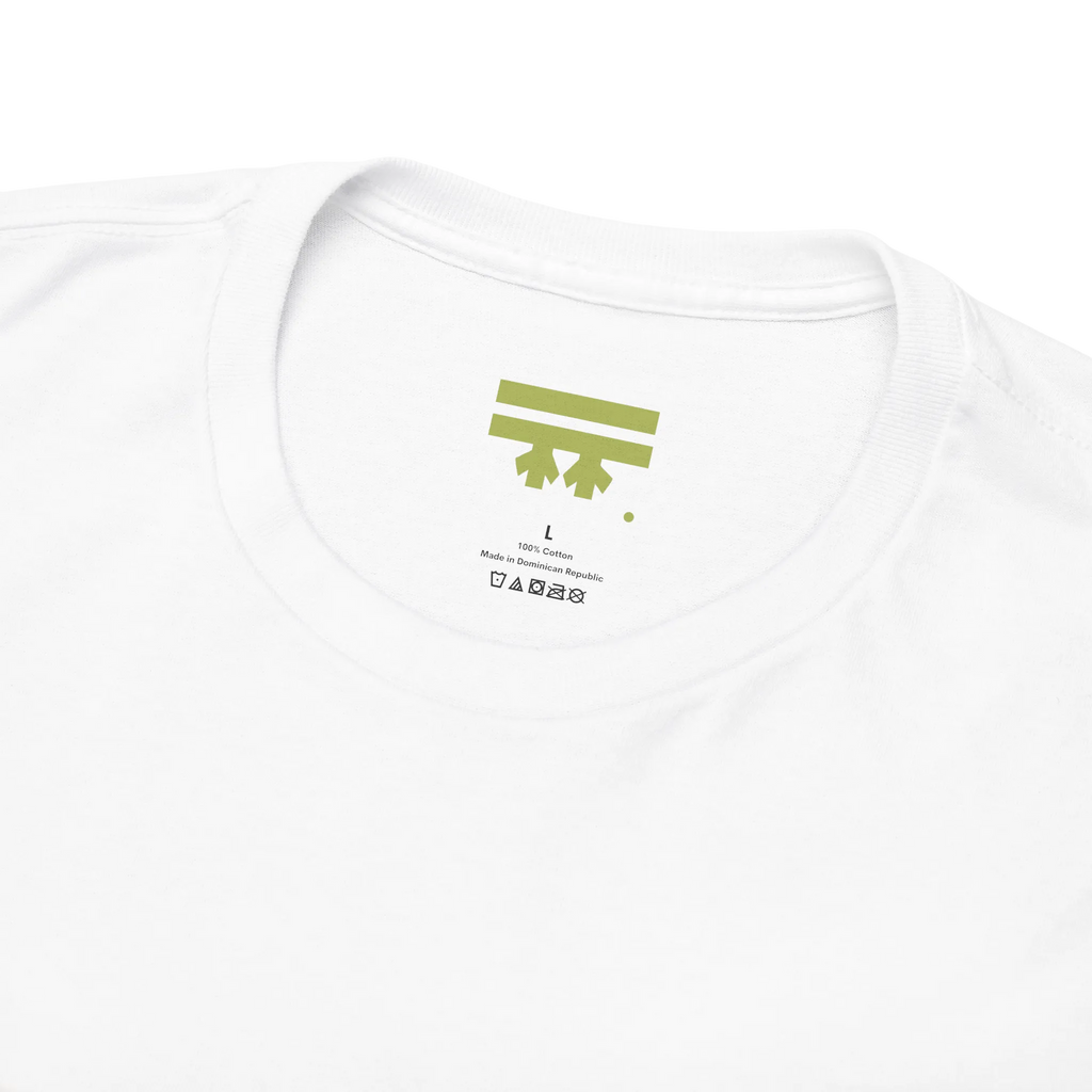 White graphic tee collar detail showing FREEBRD branded inner label, size and care info visible.