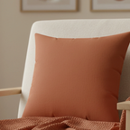 Paarl rust faux suede pillow styled on sofa, earthy boho rust home decor, lifestyle view.