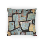 A horizontal view of the ‘Patchy’ decorative woven accent pillow with an urban abstract design that shows black and gold geometric lines.