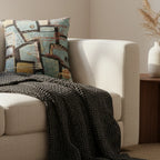 Cream bouclé curved sofa with a chunky black waffle knit throw and a pampas grass stem on a walnut side table styled with the Patchy Teal & Gold Woven Pillow.