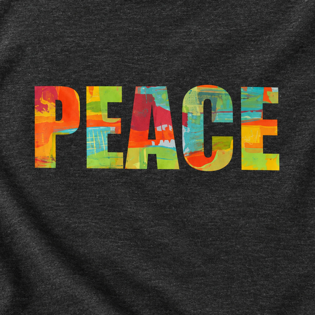 Close-up of multicolored abstract 'PEACE' lettering on a dark grey heather tee, showing the chest print and fabric texture.