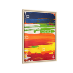 Side view of the "Primary Square" Framed Canvas Art by FREEBRD on a 1.25" canvas with an 18" x 24" Vertical frame, showcasing bold cobalt, grass green, tangerine and yellow horizontal bands with white square accents, framed in a natural wood FSC certified frame.