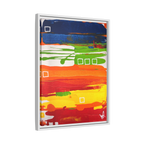 Side view of the "Primary Square" Framed Canvas Art by FREEBRD on a 1.25" canvas with an 18" x 24" Vertical frame, showcasing bold cobalt, grass green, tangerine and yellow horizontal bands with white square accents, framed in a white wood FSC certified frame.