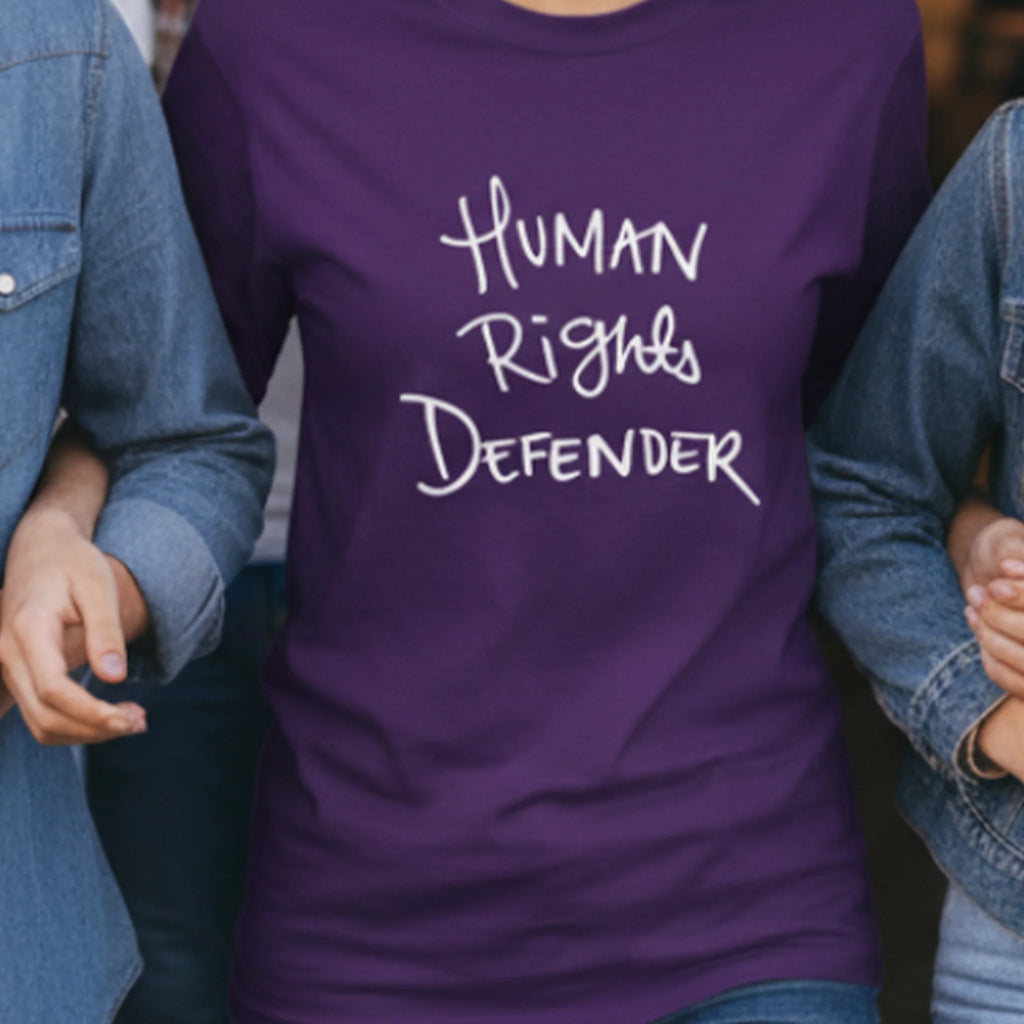 Purple Human Rights Defender long sleeve tee, white graphic, community lifestyle front view.