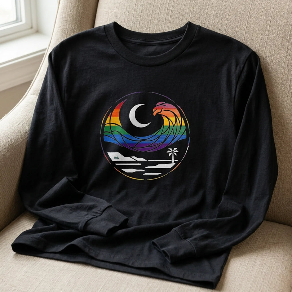 Close-up of black long sleeve tee showing the rainbow wave, crescent moon, shoreline, and palm tree chest graphic.
