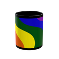 A straight on view of the black FREEBRD rainbow wave ceramic mug with a full wrap pride rainbow wave design in red orange yellow green blue and purple.