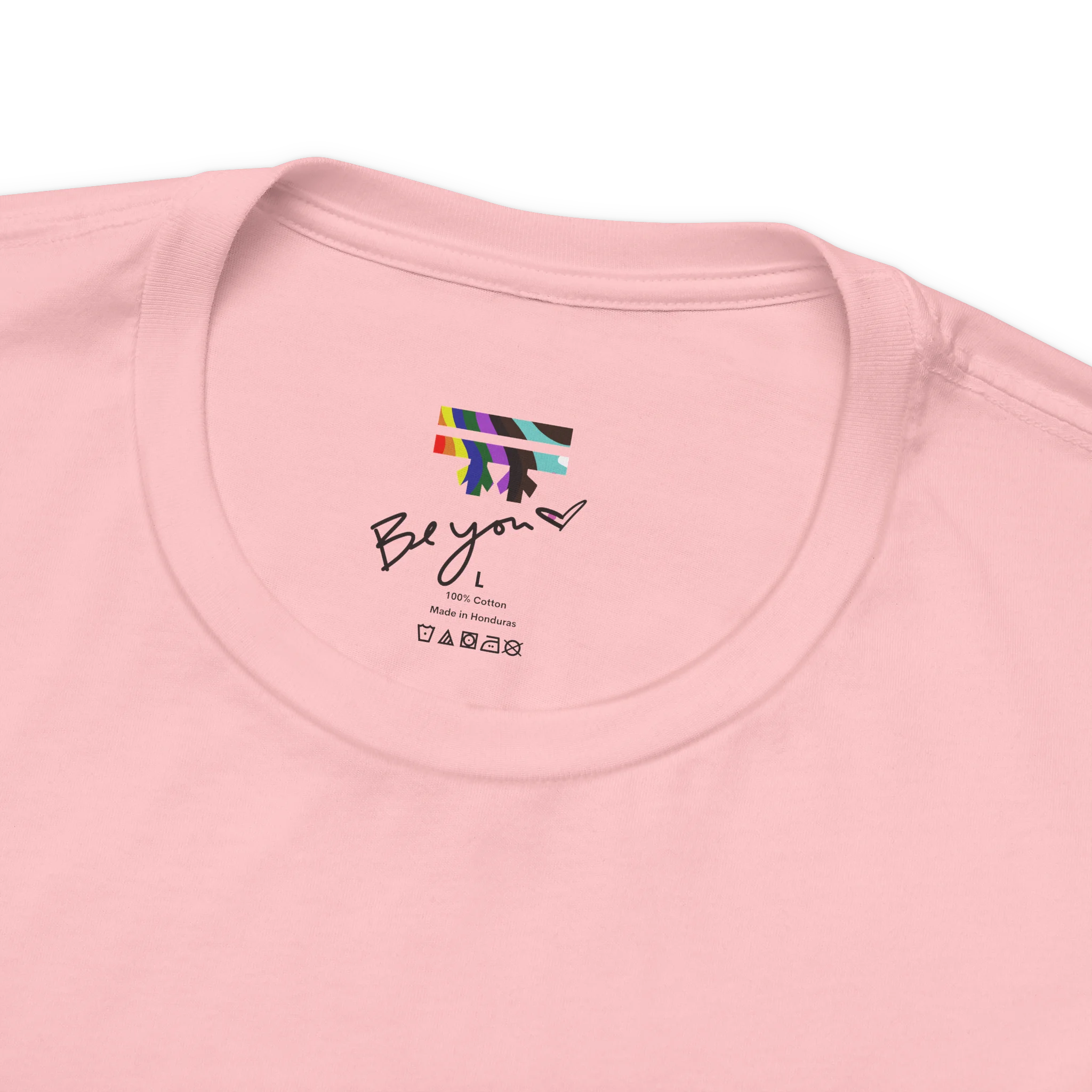Pink FREEBRD tee collar detail, Be you heart label, rainbow logo, 100% cotton, Made in Honduras, care symbols.