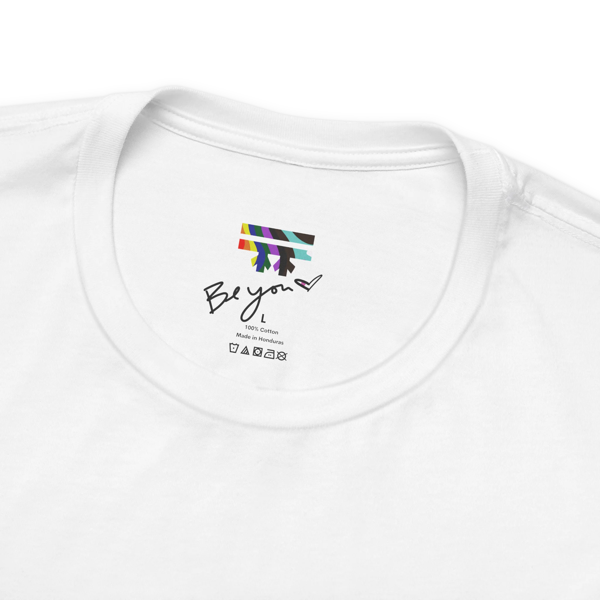 White FREEBRD tee collar detail, Be you heart label, rainbow logo, 100% cotton, Made in Honduras, care symbols.