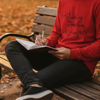 Red Bella Thinking Positive Thoughts long sleeve tee, handwritten graphic, outdoor park lifestyle front view.