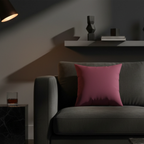 Red onion faux suede throw pillow styled on a sofa in a moody modern living room.