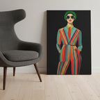 A size reference shot of the Freebrd "Retro Fashionista Chic Portrait" Vector Mod Pop Art design on a 24" x 36" (Vertical) 1.25" inch thick canvas showing a stylish retro chick wearing a pinstripe suit, red tie and circle sunglasses, laying vertical against a wall next to a modern sofa chair.