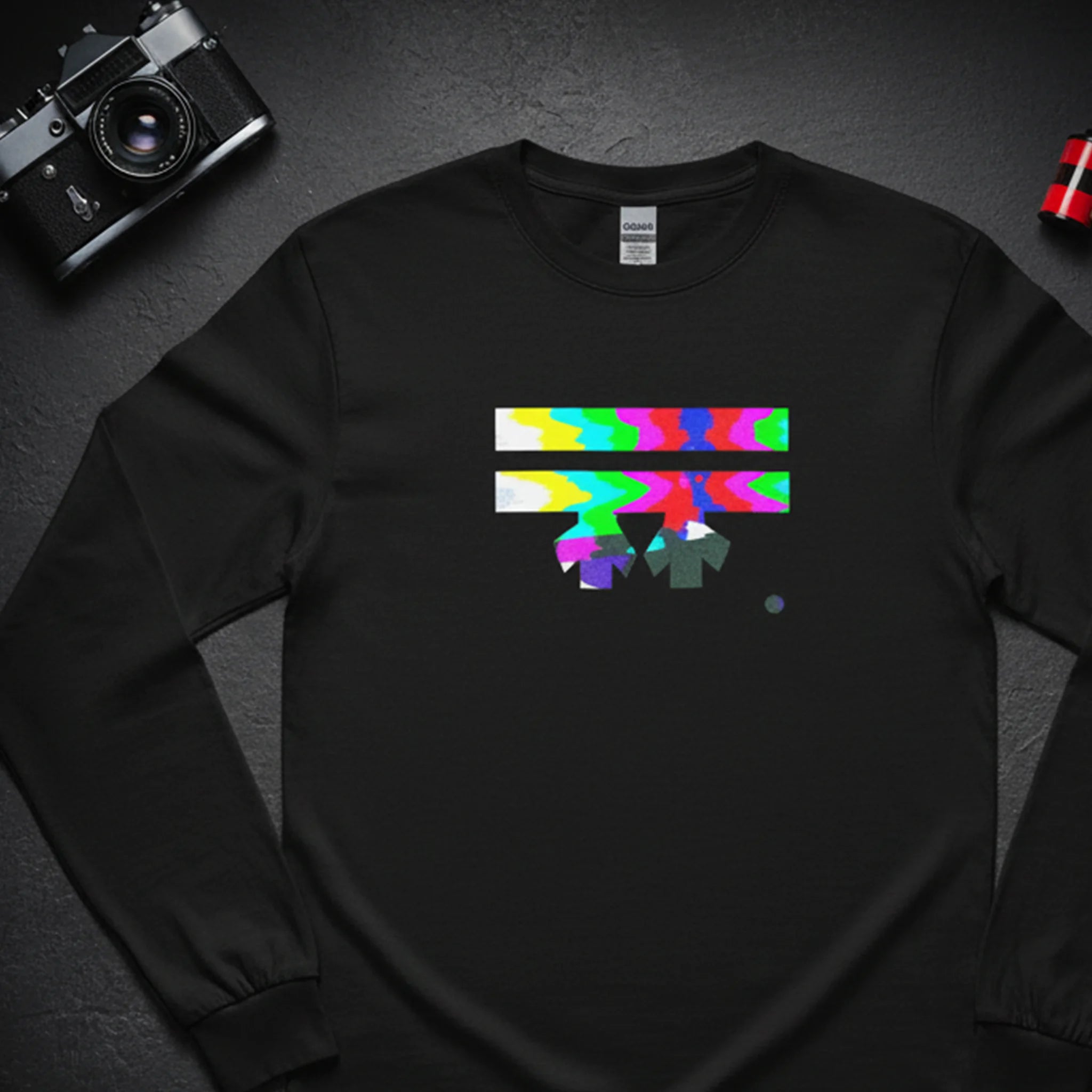 Black Retro Glitch long sleeve tee, FREEBRD logo in analog TV static glitch graphic, bird's eye flat lay view.