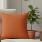 Roman earth faux suede pillow styled on sofa, earthy terracotta home decor.