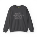 Dark grey heather crewneck sweatshirt with light-colored 'Rooted in strength, walking in grace' lettering across the chest, front flat lay.