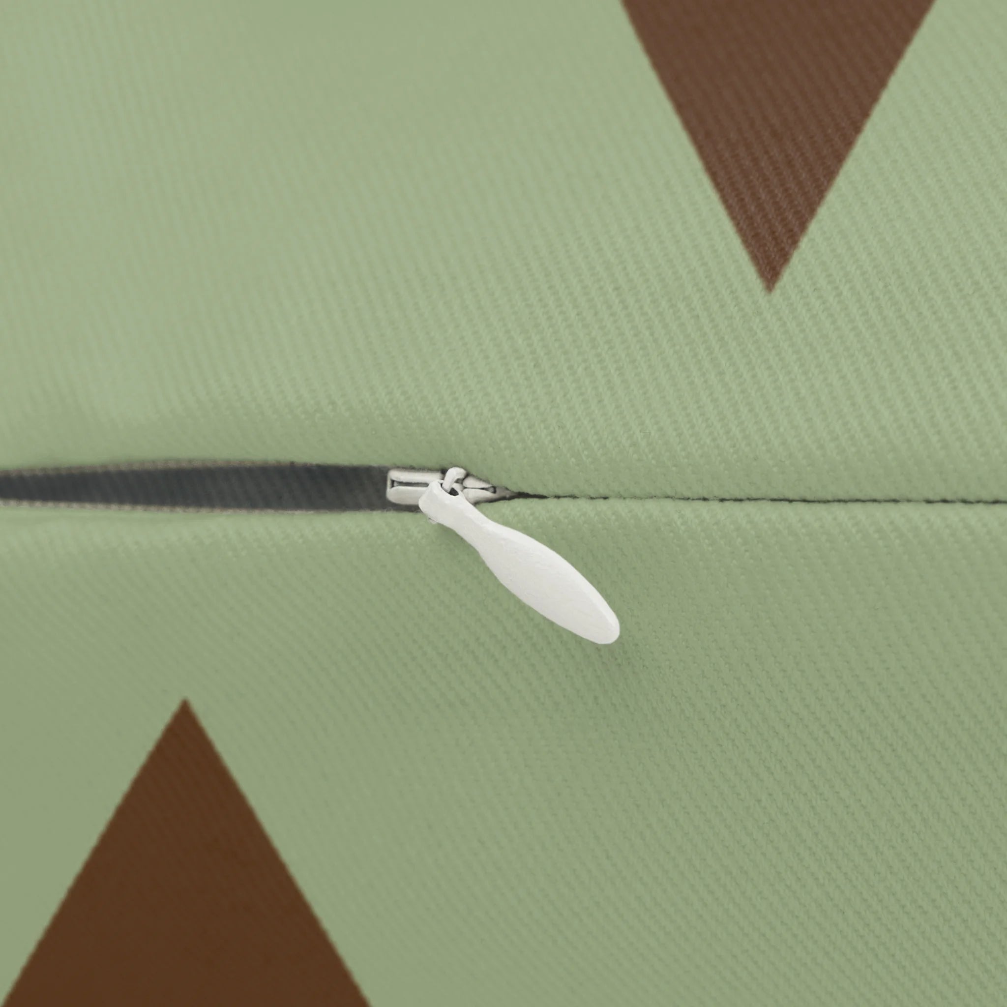 Sage chocolate triangle pattern lumbar pillow, zipper view.