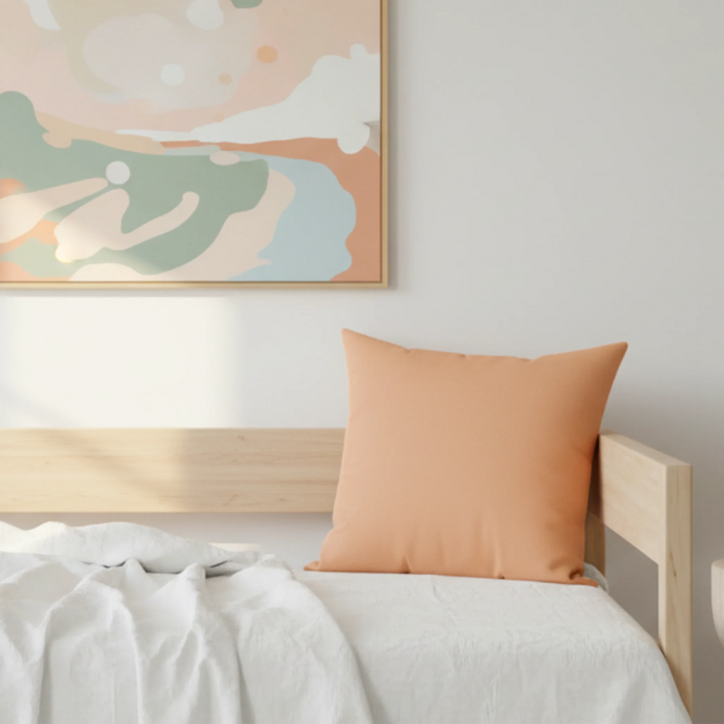 Sandy peach faux suede throw pillow on a minimalist day bed with abstract wall art, lifestyle view.
