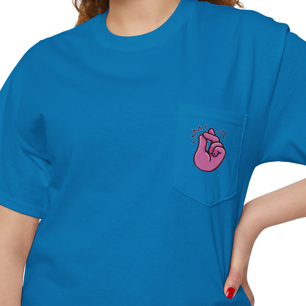 A person wearing a FREEBRD sapphire classic cotton pocket t-shirt with a baby pink cartoon finger-snap Clock It graphic printed on the front chest pocket.