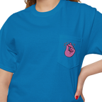 A person wearing a FREEBRD sapphire classic cotton pocket t-shirt with a baby pink cartoon finger-snap Clock It graphic printed on the front chest pocket.