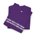 Purple cotton t-shirt folded in a stack with the white printed front text visible at an angle.